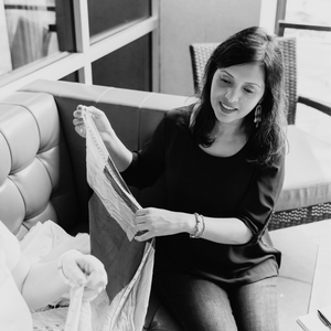 Munira Syeda looking at fabric